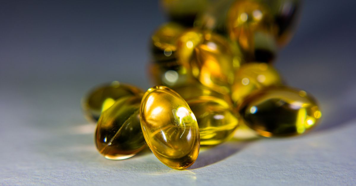 Vibrant close-up of golden softgel capsules, perfect for health-related content.