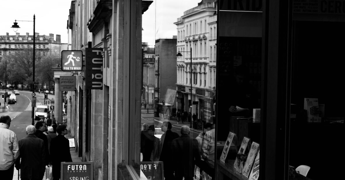 Monochrome street photograph capturing daily life in Bristol, England.