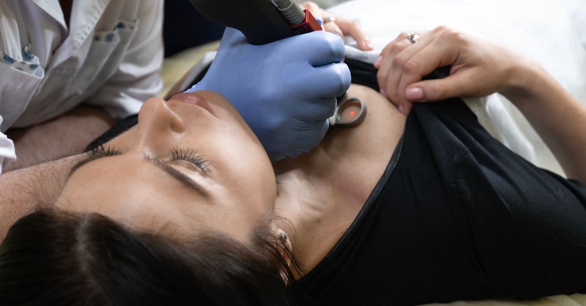 Close-up of a woman receiving dermatological treatment in a clinical setting.