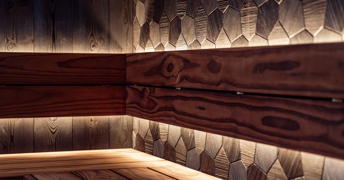 A beautifully crafted indoor sauna showcasing Nordic design with warm LED lighting.