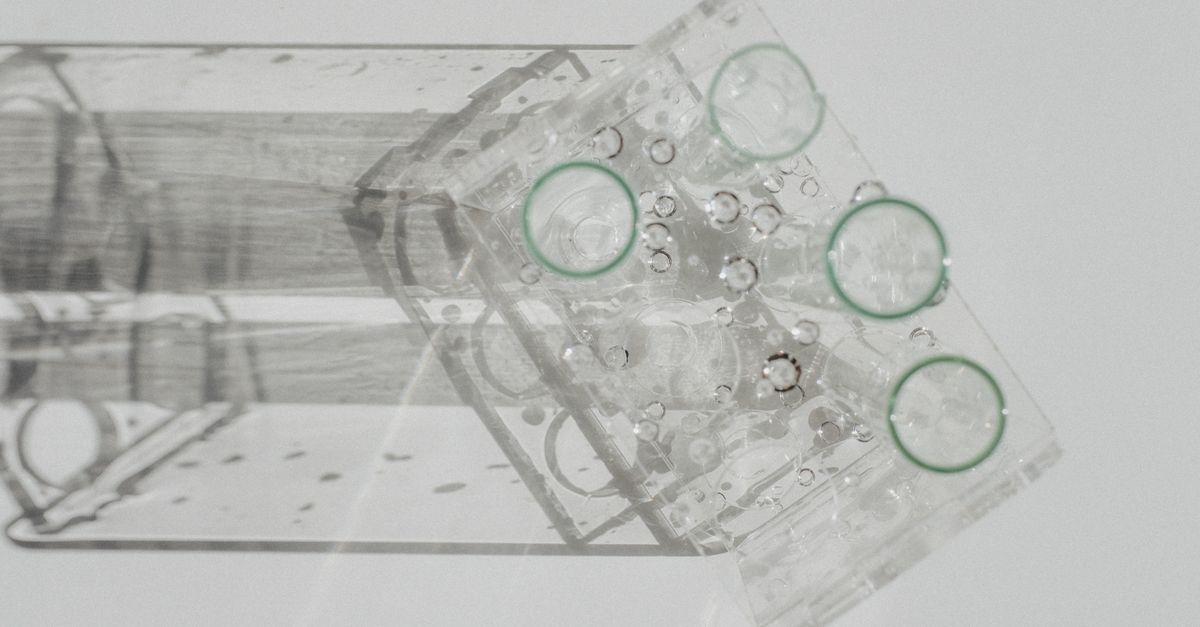 Laboratory glassware setup viewed from above on a white background, featuring various flasks.