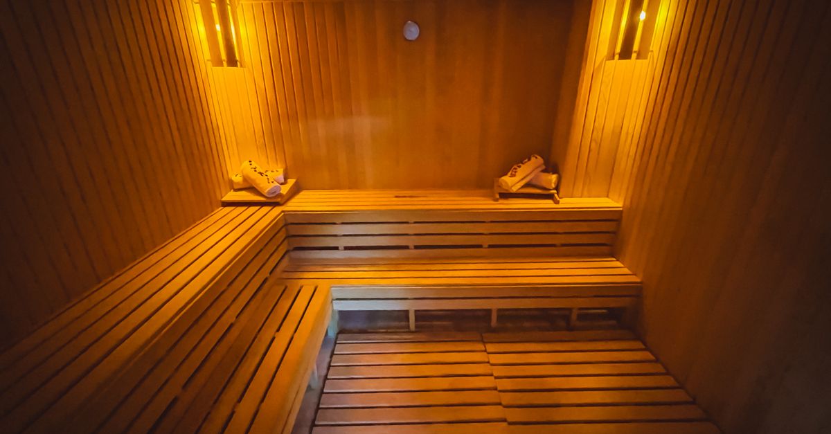 A cozy wooden sauna interior with warm lighting creating a relaxing atmosphere.