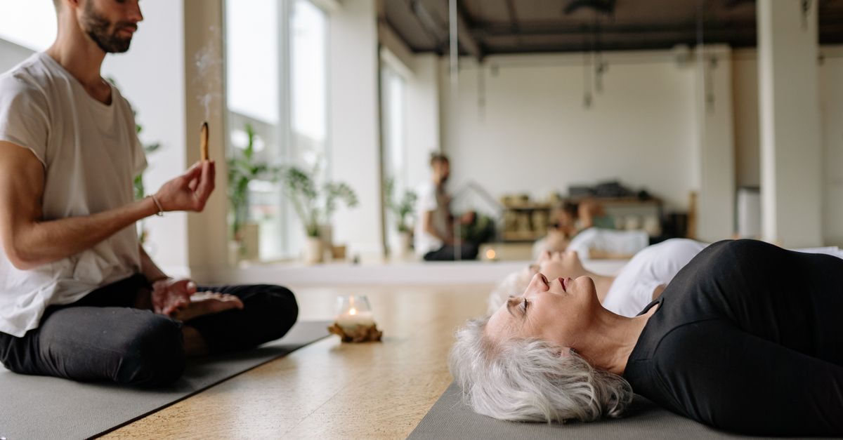 Yoga and meditation session in a serene studio with incense and relaxation.