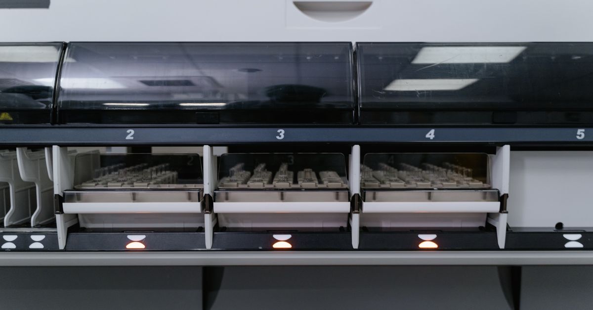 Automated laboratory machine analyzing multiple test samples in healthcare research facility.