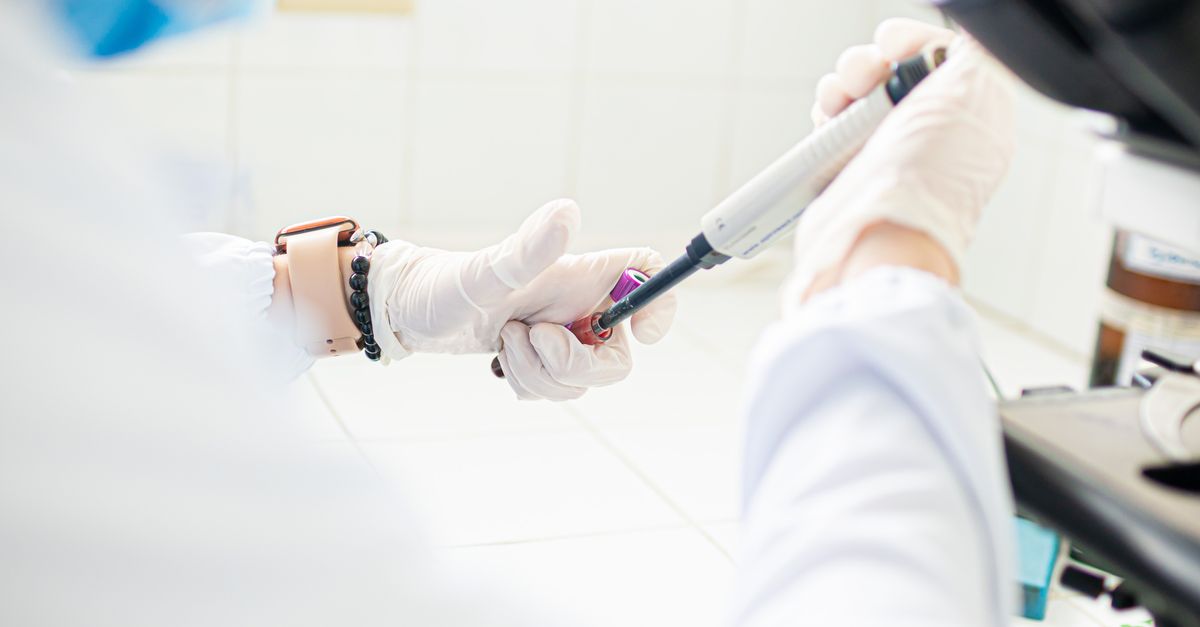 A medical professional using pipette in a lab setting, emphasizing precision and care.