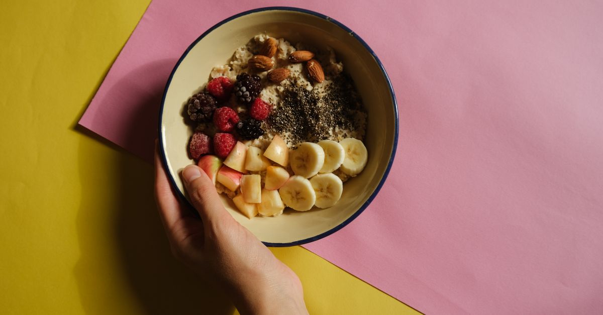 A vibrant oatmeal bowl with fruits and nuts on a pastel background, perfect for healthy breakfast ideas.