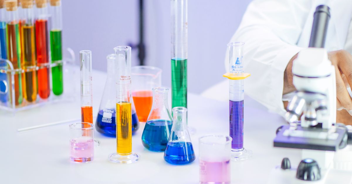 Vibrant laboratory setup with beakers, flasks, and microscope for scientific research.