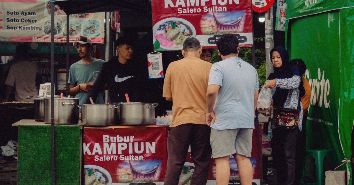 Lively street food scene at a Jakarta bazaar with diverse local cuisine.