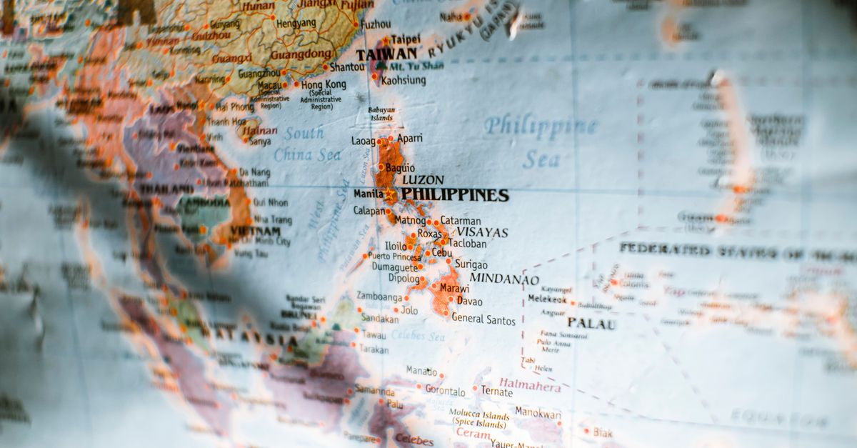Closeup of paper world map with selective focus of Philippines surrounded by seas