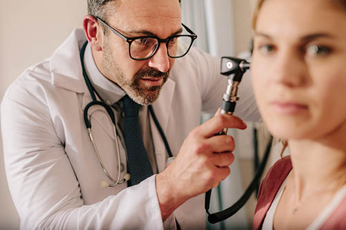 An ENT specialist using Otoscope for better imaging of the ear canal