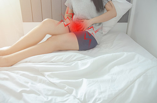 female holding vagina in pain