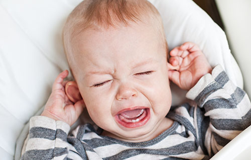 ENT problems in the kids, crying kid holding the ear, ENT specialist
