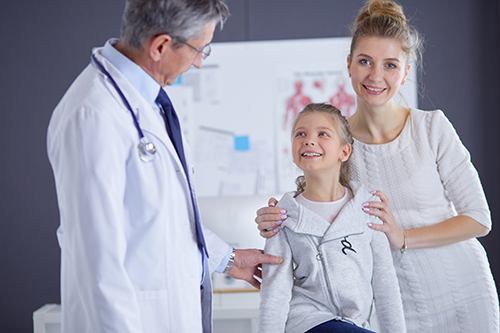 an ENT specialist consulting with a kid and her mother