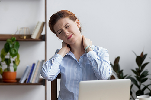 Image of office employee suffering from neck pain