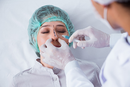 an image showing a patient under the procedure of a nose job