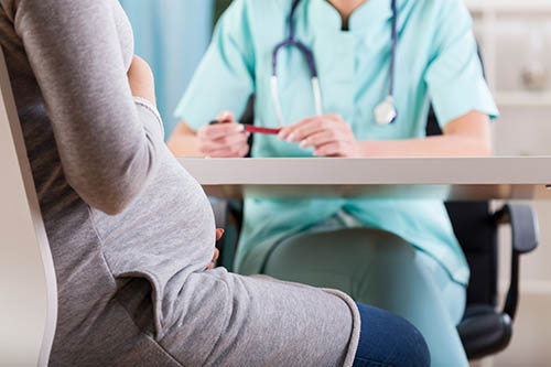 pregnant woman having a consultation with gynecologist