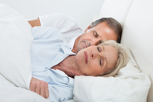 Elderly couple in bed