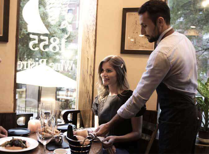 Waitor serving food to woman