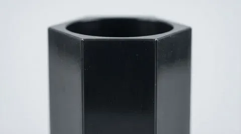 Close up view of hexagonal tube surface showing smooth glossy finish