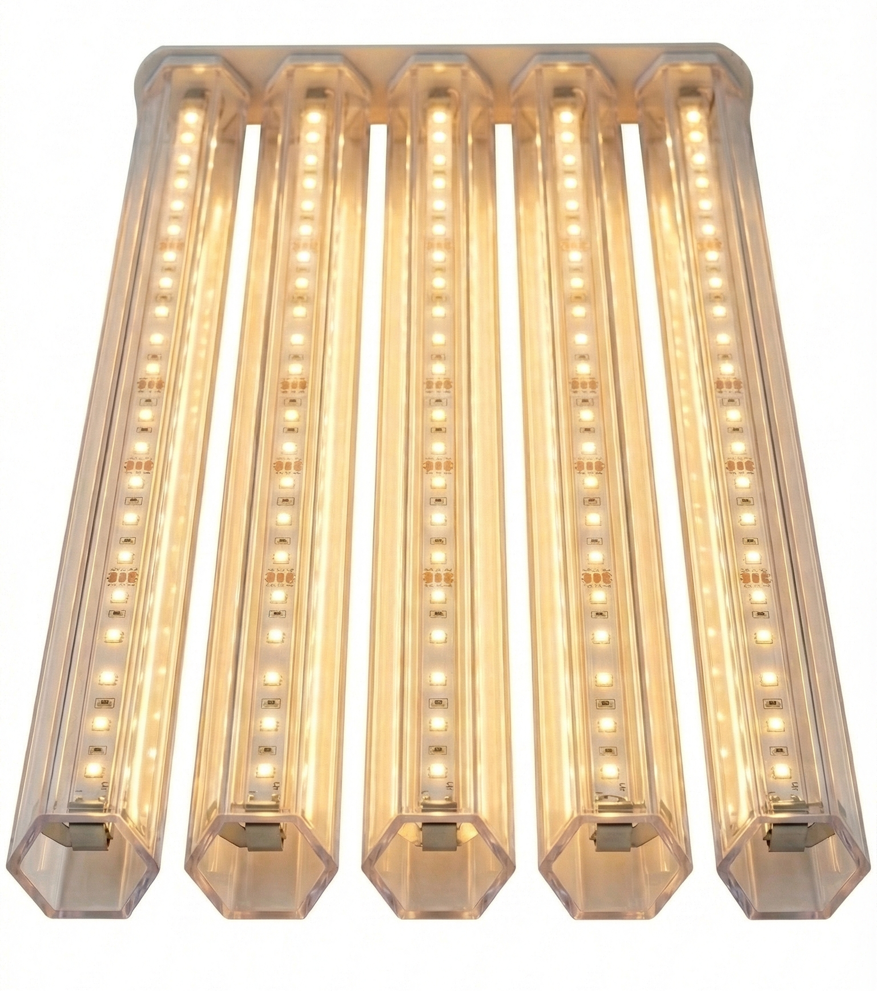 Transparent hexagonal tubes covering LED strip lights on ceiling, warm glow through tubes, real lighting application