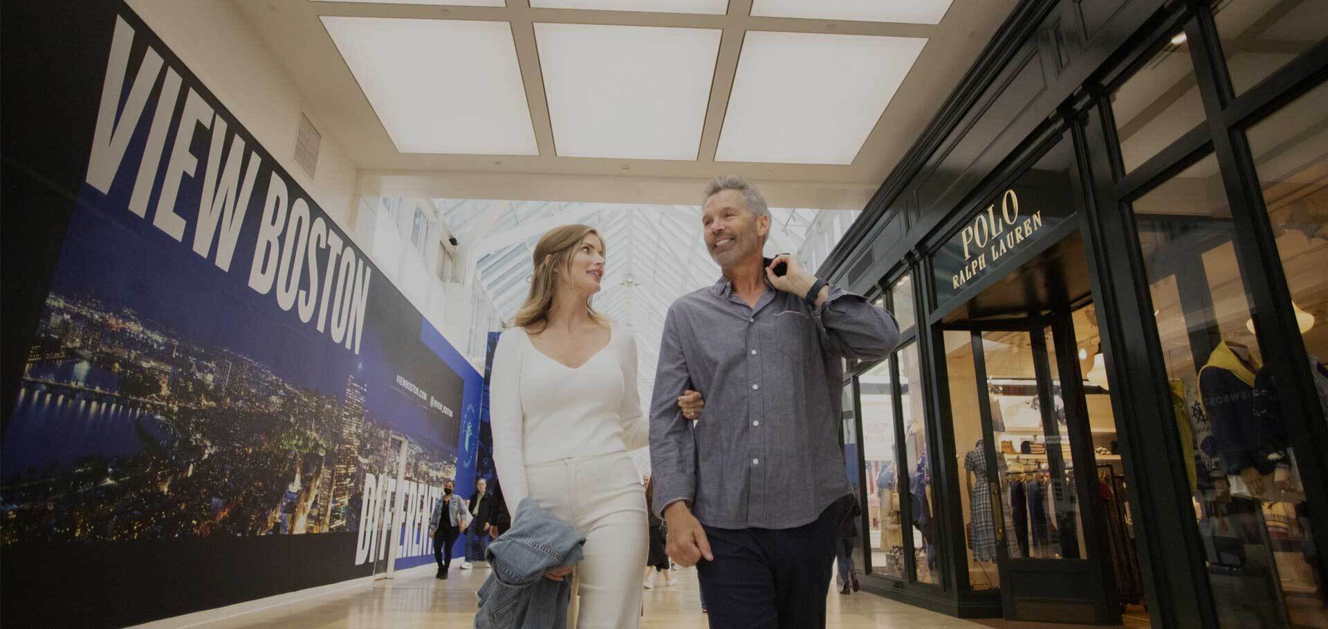 Couple walking by stores