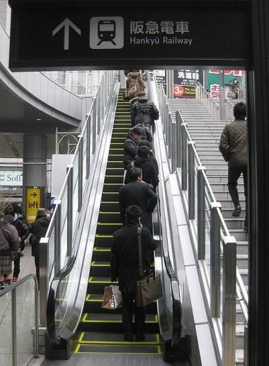 Escalator with people standing on one side