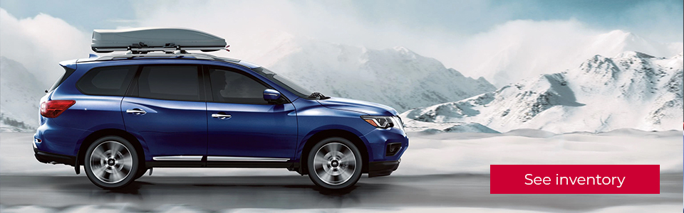 View inventory: Image of the blue Nissan pathfinder in a cold winter landscape with snow covered mountains