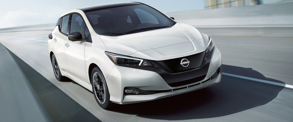 White 2023 Nissan Leafs in action