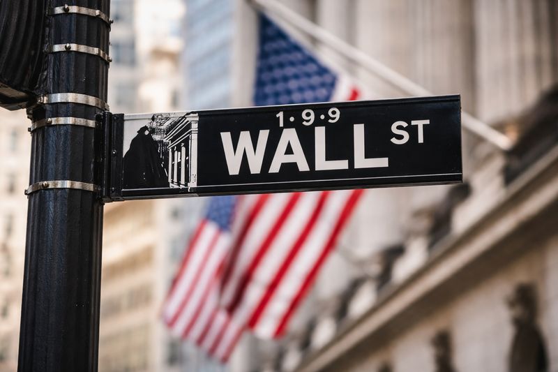 Dow hits record high before fading as chip selloff weighs on Nasdaq