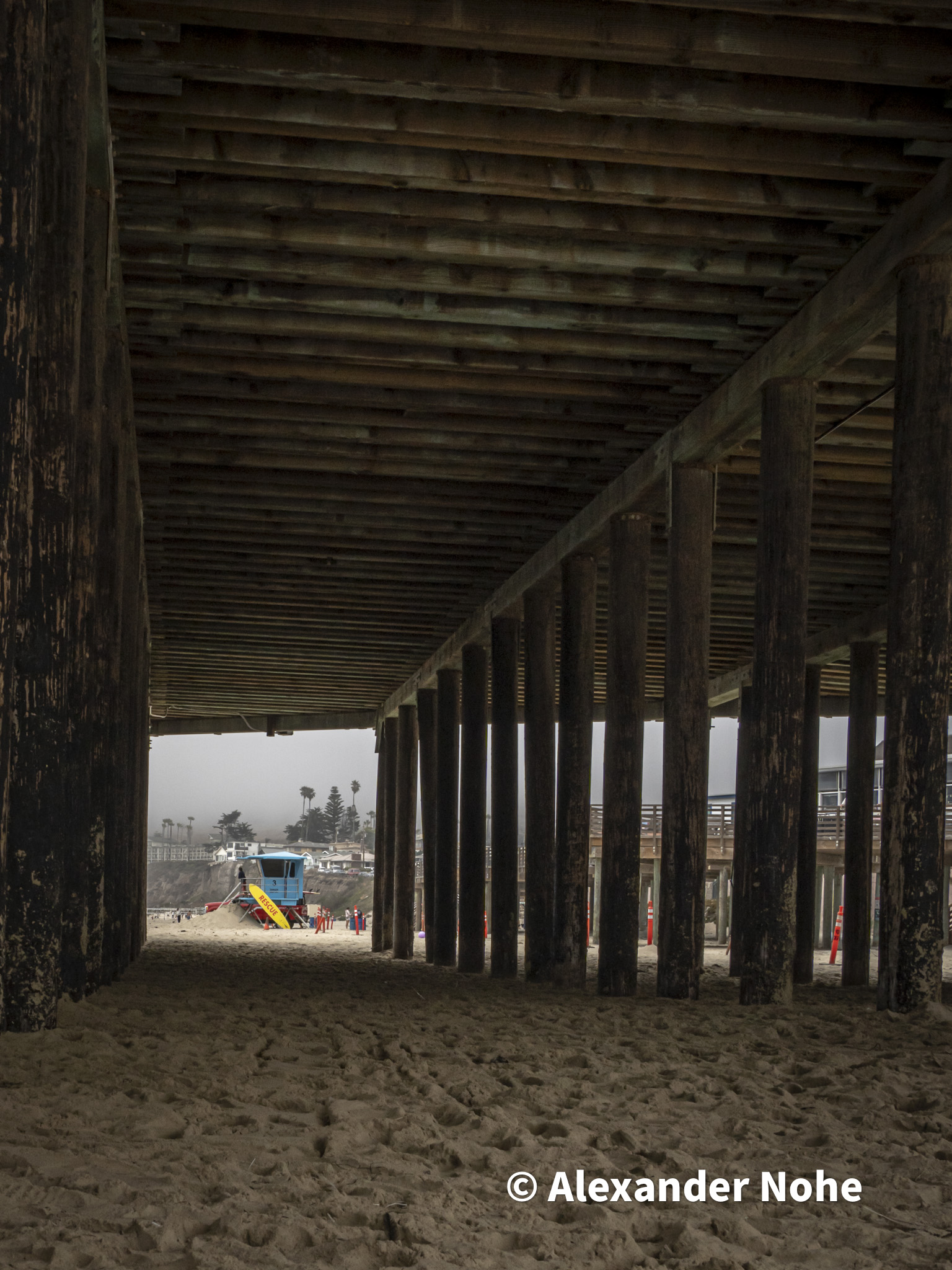Underneath the Pismo Beach wooden pier pillars