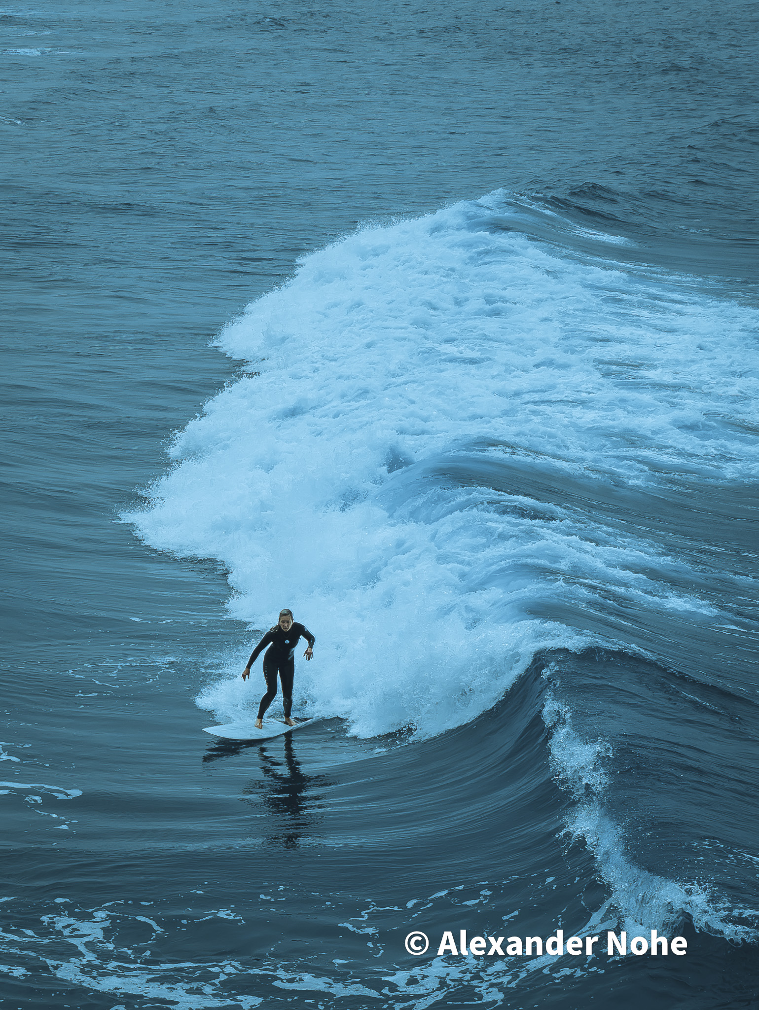 A surfer catching a large wave