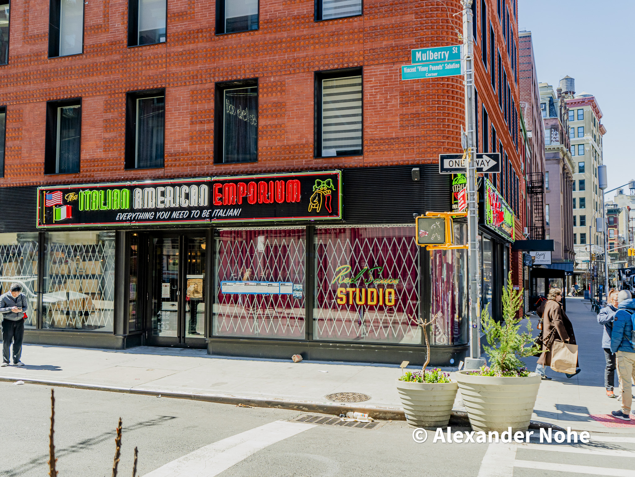 Italian American Emporium on Mulberry Street with neon signs