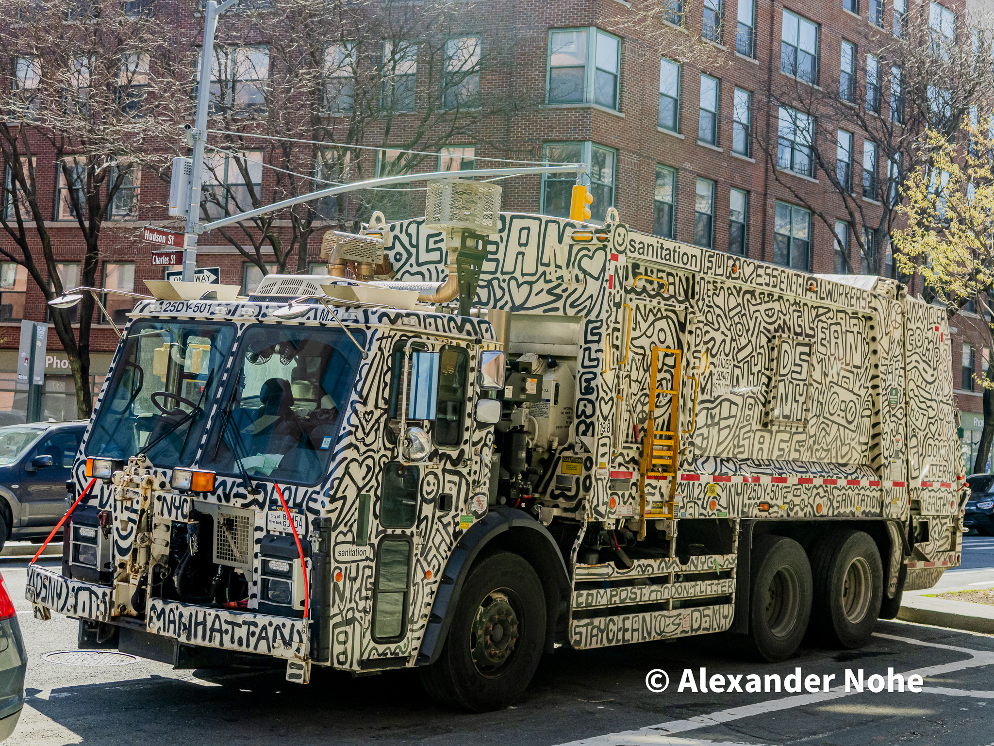 Garbage truck covered in black-and-white doodle street art