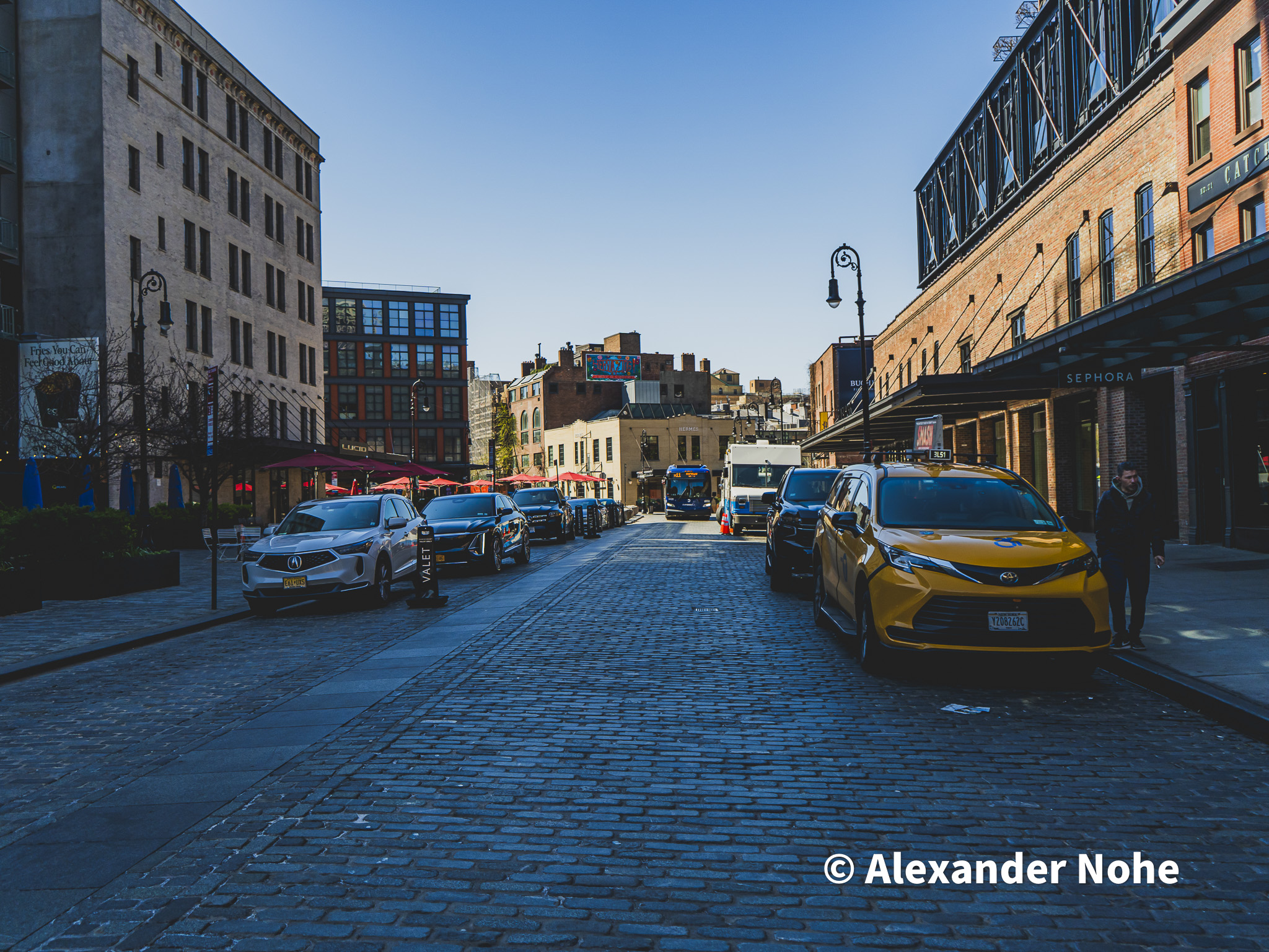 Yellow taxi cab on a cobblestone street