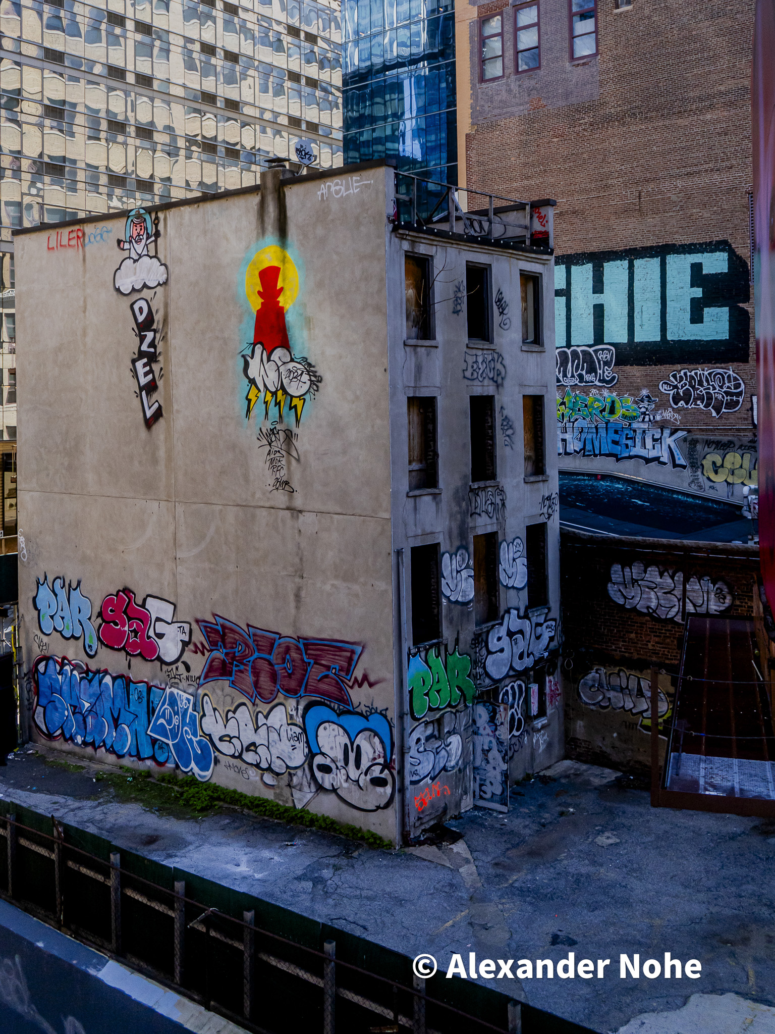 Small urban building covered in colorful street art