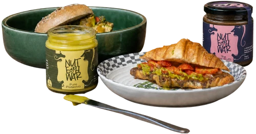 Breakfast bowl, open Pure Pistachio jar, croissant plate, and The Dark Truth jar