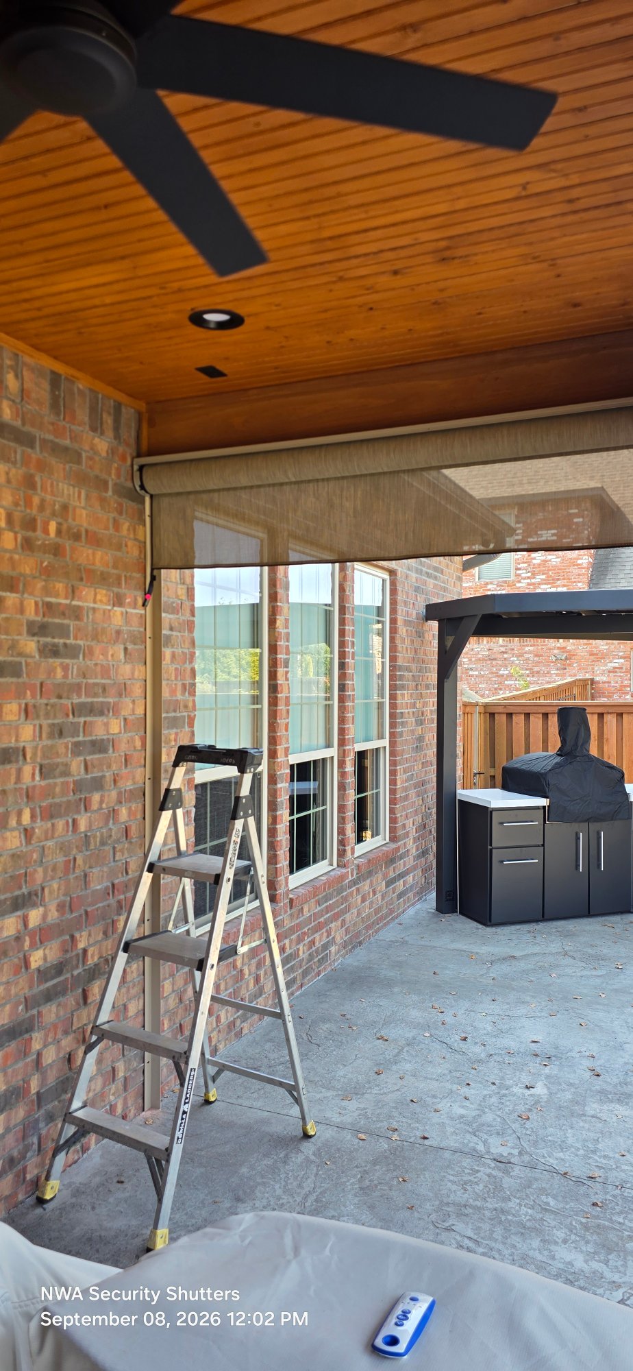 Aluminum roll screen installed in housing.