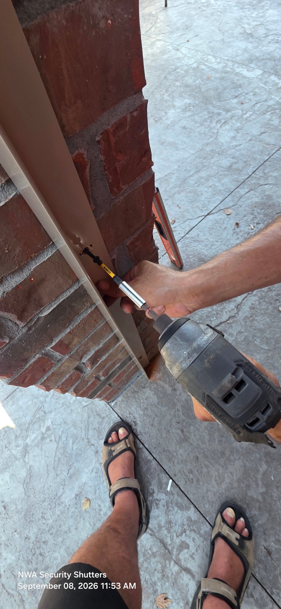 Tapcons into brick and mortar.