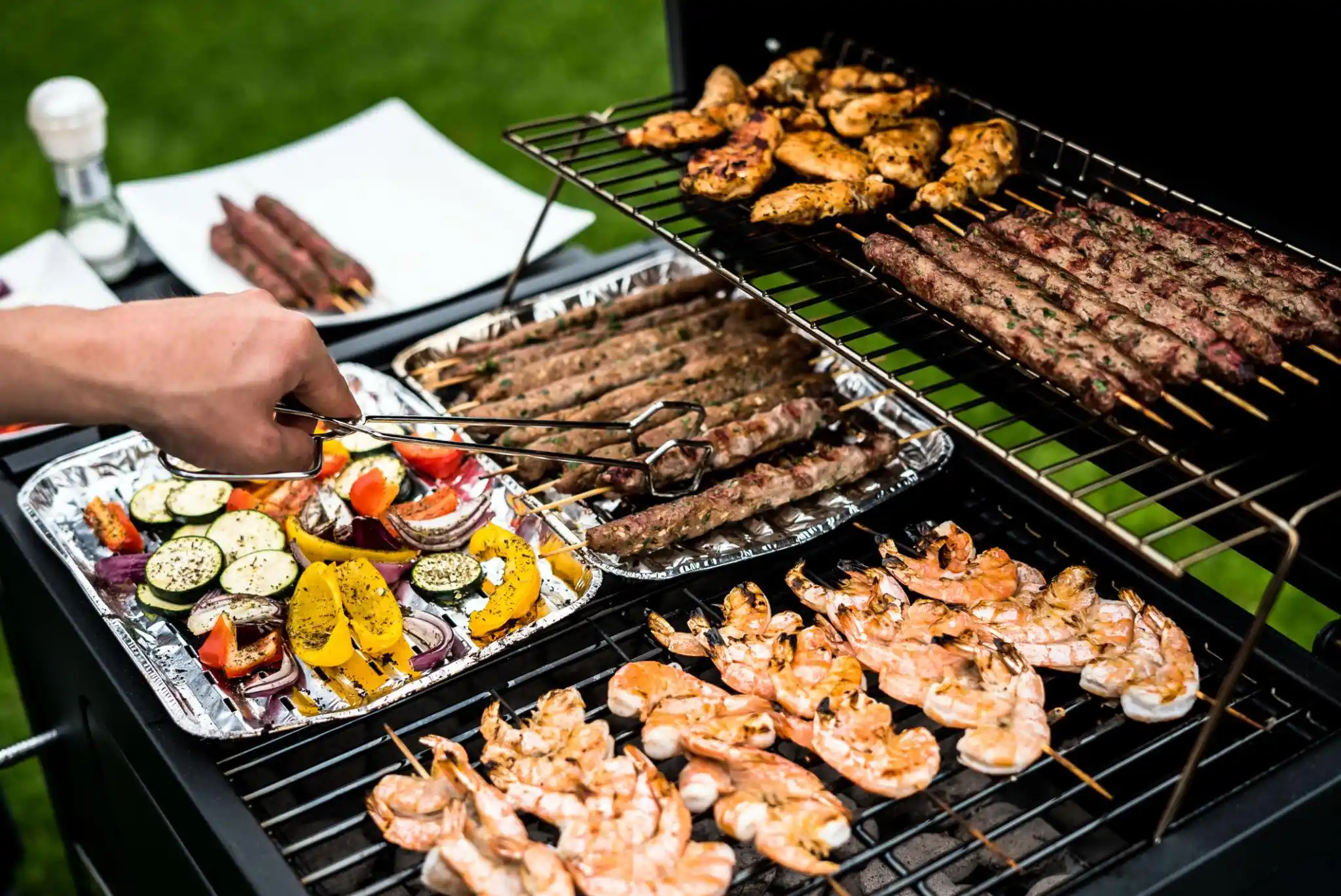 Chicken and shrimp cooking over a hardwood charcoal grill