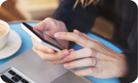 Person using phone and laptop