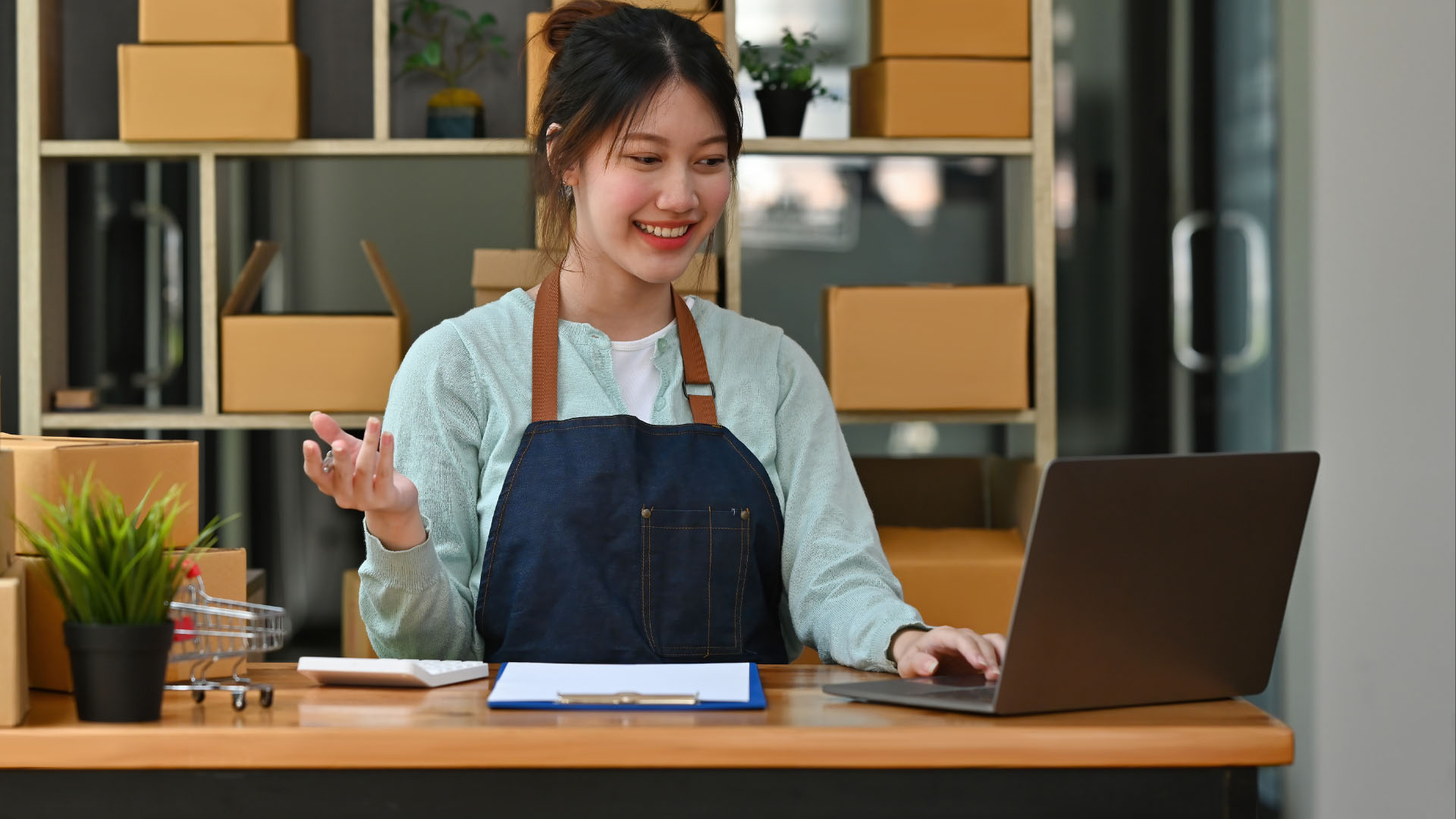Retailer managing inventory on a laptop