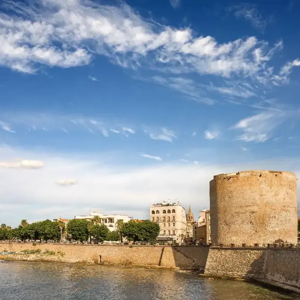 This image displays excellent quality across all criteria. The composition is well-balanced, highlighting the historical tower against a vibrant blue sky and waterfront. Lighting is superb, contributing to the photo-realistic appearance and accurate colors. The image is sharp throughout, with all key elements, especially the tower and surrounding architecture, clearly in focus.