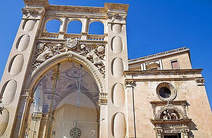 The image is of high quality, showcasing an intricate architectural facade under clear blue skies. Strengths include excellent sharpness, photo-realism, and natural lighting that beautifully accentuates the stone details and carvings. The colors appear accurate, and key elements are in focus. The composition is generally strong, though the framing slightly cuts off parts of the building on the right and bottom, which could be improved for a more comprehensive view of the structure.