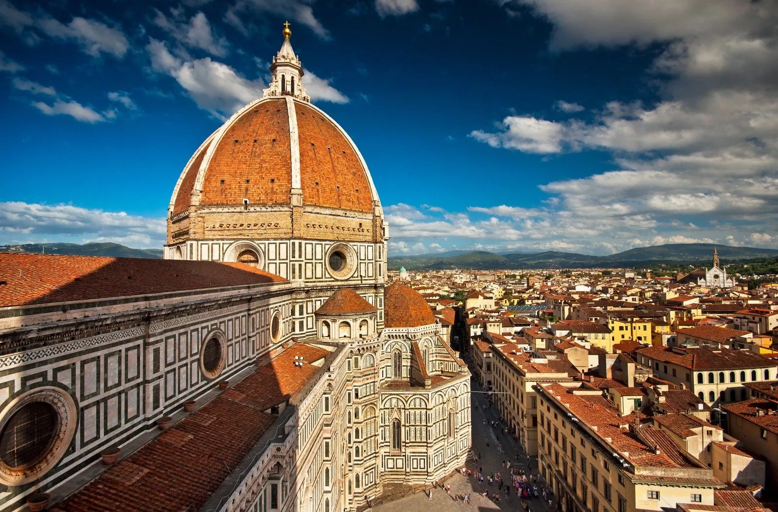 The image showcases excellent composition, prominently featuring the Florence Duomo from an elevated perspective, with the cityscape stretching into the background under a vibrant blue sky. Lighting is natural and even, enhancing architectural details. The image is highly sharp with good focus on all key elements, and colors appear accurate and photo-realistic.