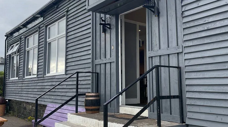The image is sharp and photo-realistic with accurate colors and all key elements in focus. The composition is decent but could be improved, as the top of the doorway is slightly cut off. The lighting is natural but somewhat flat, lacking stronger contrast.
