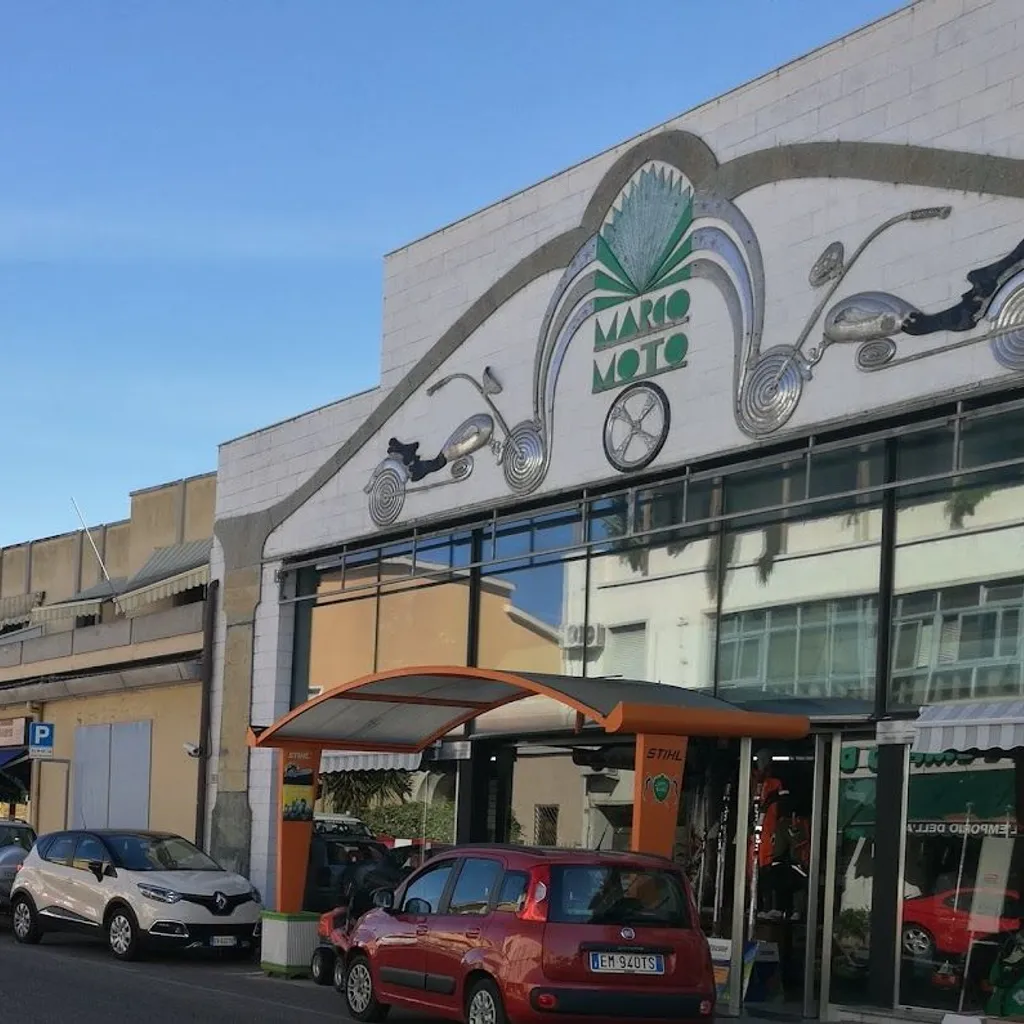 The image depicts the exterior of a motorcycle business, 