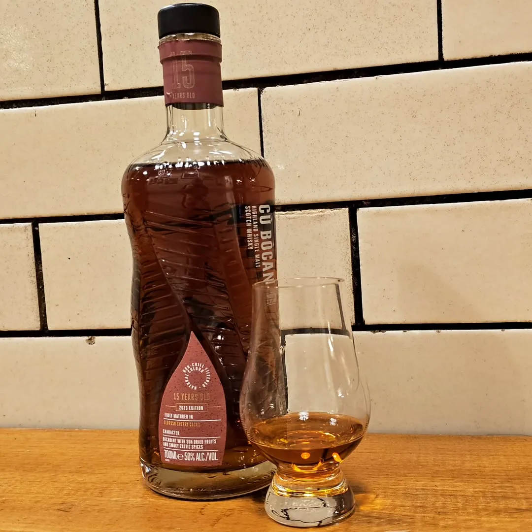 The image features a well-composed shot of a whisky bottle and a tasting glass, demonstrating good photo-realism and sharp focus on the key elements. The colors appear accurate. While the lighting is decent, it could be improved for more even illumination and vibrancy, particularly on the background and left side of the bottle, preventing a slightly dim appearance.