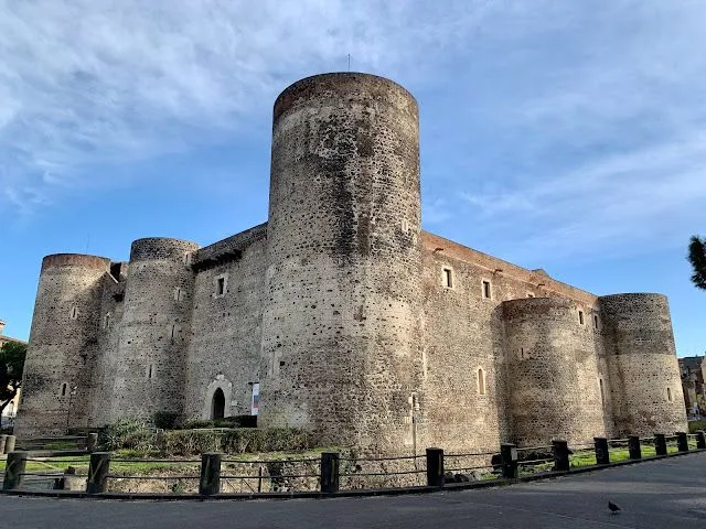 A well-composed and sharp image of a stone castle under a blue sky. The main tower and walls are clearly visible, with good detail in the stonework.