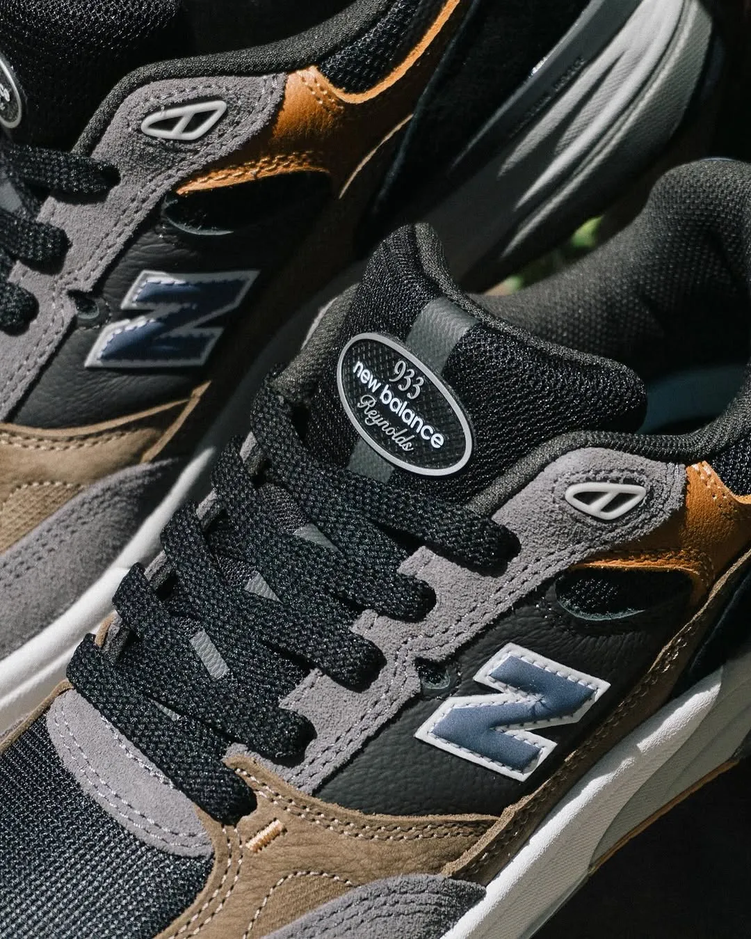 A professionally taken, close-up photograph of New Balance sneakers, showcasing the texture, details, and branding of the footwear. The image is sharp, well-lit, and color-accurate.