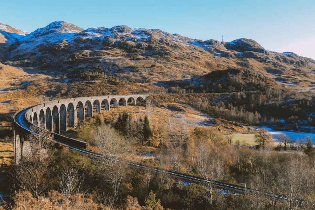 This image is an excellent example of exterior landscape photography, showcasing a majestic viaduct winding through a mountainous, snow-dusted terrain. The composition is exceptionally well-executed, with the viaduct acting as a strong leading line that guides the viewer's eye through the vast landscape. The image is perfectly well-lit, captured under clear skies which provide natural, even illumination without harsh shadows or overexposed areas. Sharpness is outstanding across the frame, with both the prominent viaduct and the intricate details of the distant mountains and foreground foliage appearing crisp and clear. The colors are highly accurate and vibrant, reflecting the natural hues of the environment, from the clear blue sky to the earthy tones of the hills and the white of the snow. The image is highly photo-realistic, presenting an authentic and immersive view of the scene. All key elements, especially the viaduct and the railway tracks, are in sharp focus, contributing to the overall high quality. There are no unwanted elements present.
Score: 100
Strengths:
- Exceptional composition with a strong focal point and leading lines.
- Perfect lighting, showcasing the scene clearly and naturally.
- Outstanding sharpness throughout the image.
- Highly accurate and natural color reproduction.
- Fully photo-realistic.
- All key elements are perfectly in focus.
Weaknesses:
- None identified based on the provided criteria.